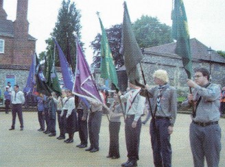 Scouts standing with flags outside Winchester Cathedral