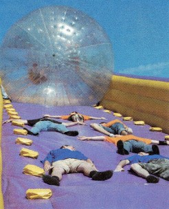 A group of Explorer Scouts lay down in front of a transparent zorb.