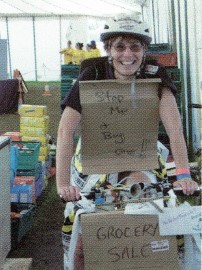 A Scout on a bike wearing a sign that reads 'Stop me, buy one'