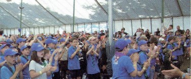 A large number of young people in a tent for the closing ceremony.