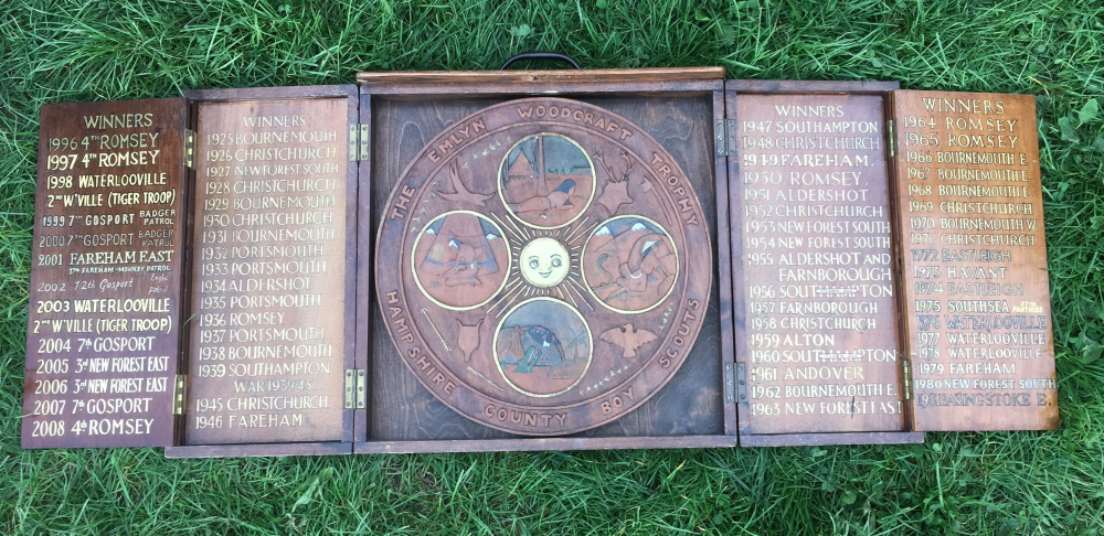 The Emlyn trophy, a camping competition run for over a century. The trophy consists of a decorated circular design with boards flanking either side with the names of previous winners.