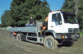 A scout irons on the back of a stuck flat bed truck