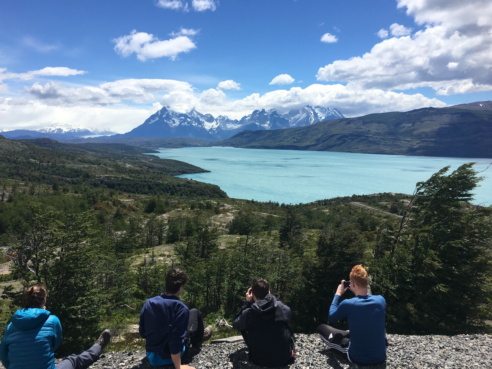 A group of Scouts overlook a lake and mountains in Switzerland