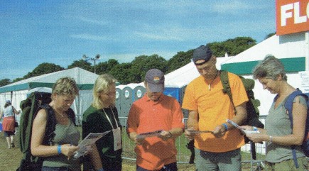 Norwegian Scouts read the daily campsite paper