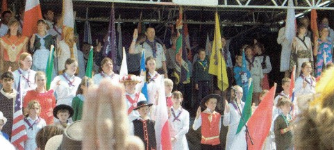 Scouts dressed in a variety of traditional country dresses make the Scout promise