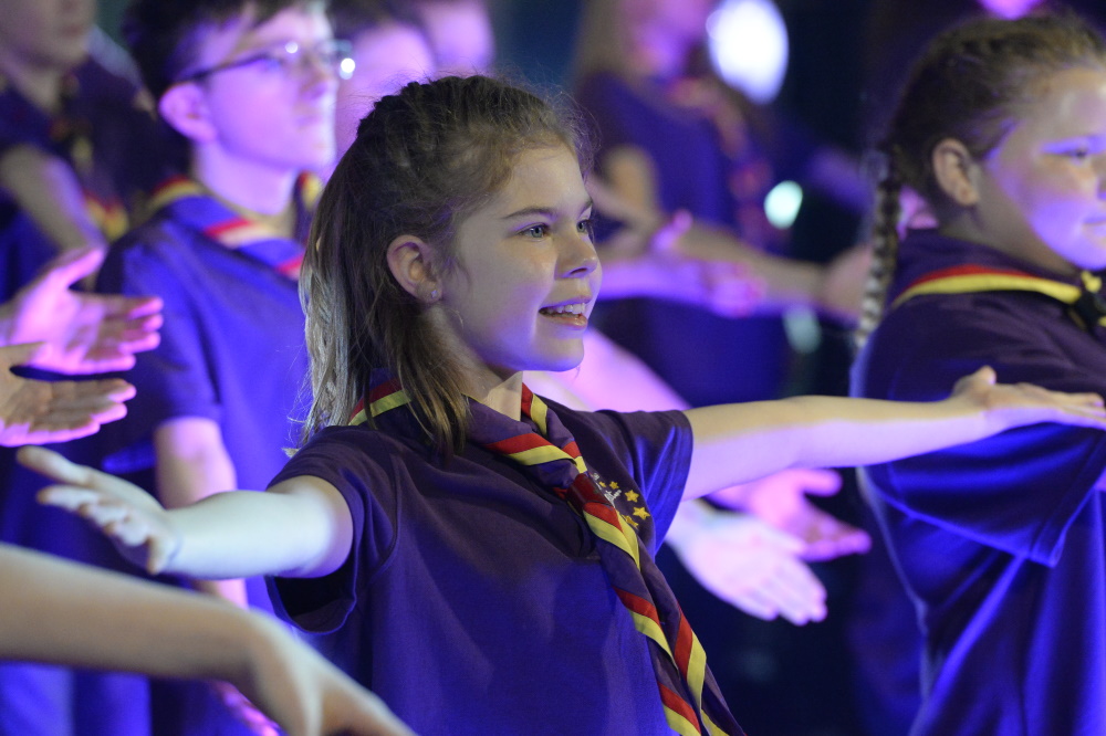 A girl Scout performing in a show