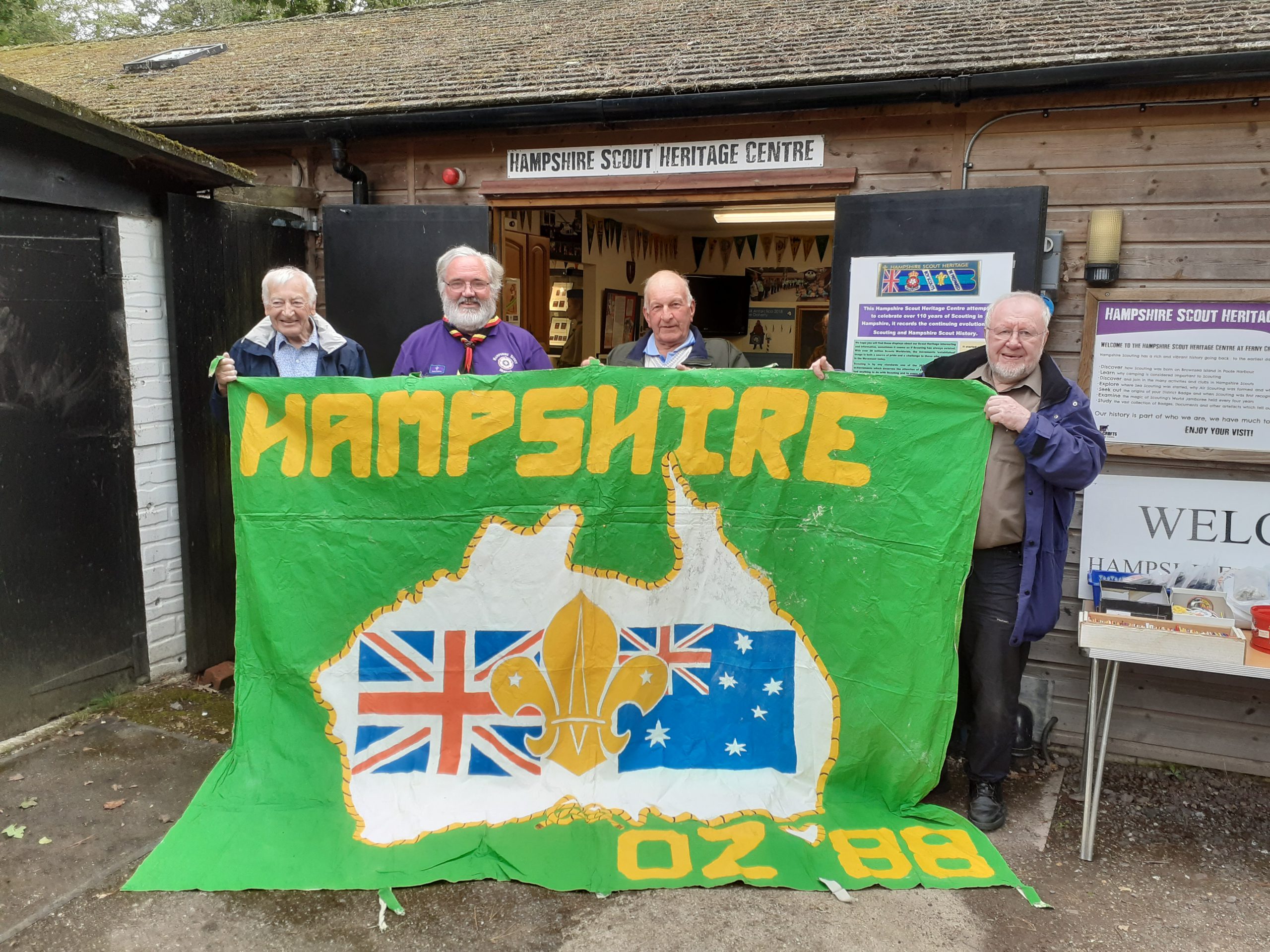 Hampshire Scouts Heritage volunteers hold up a banner.